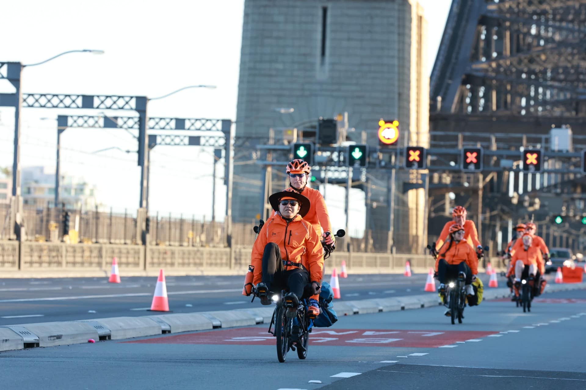 Three Pino tandems with three pilots and two riders in orange jerseys, ready to ride.