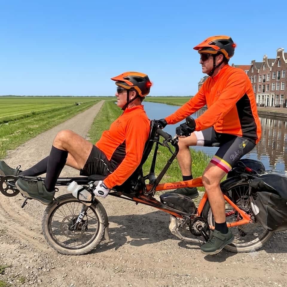 A Hase Pino semi-recumbent tandem, front seat reclined low and the pilot seat upright behind.
