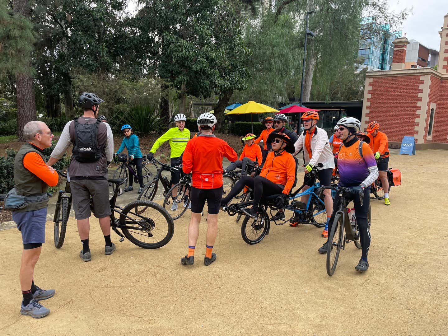 Three Pino tandems with three pilots and two riders in orange jerseys, ready to ride.