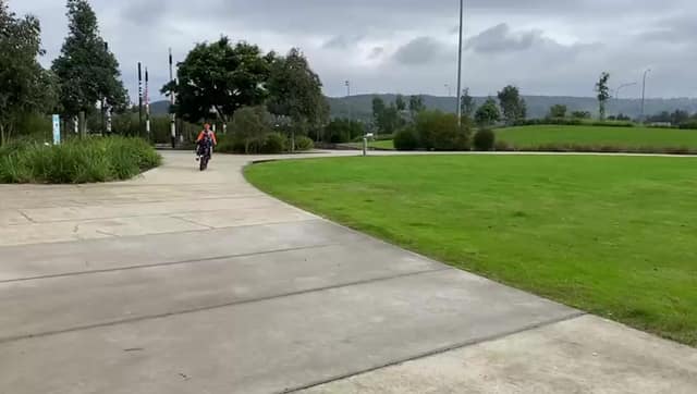 A rider on a park path during a Vision Australia ride.